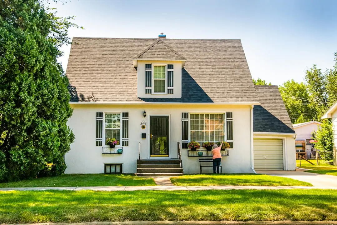 man-in-black-shirt-sitting-on-chair-near-white-wooden-house-during-daytime-w8z6aiwfi1e